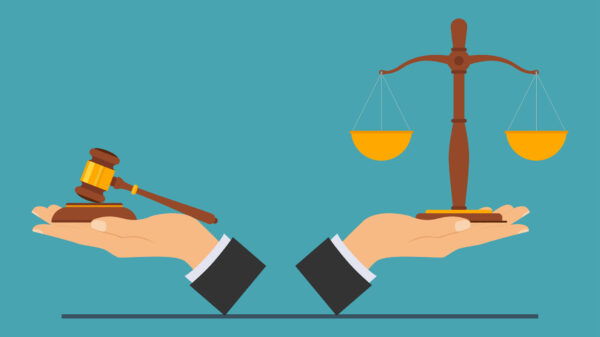 hands holding legal scales and gavel