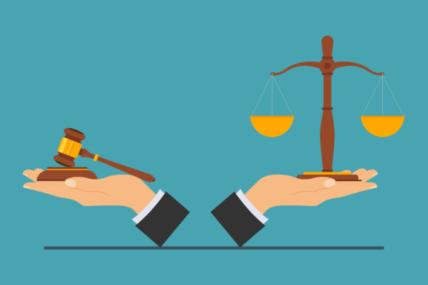 hands holding legal scales and gavel