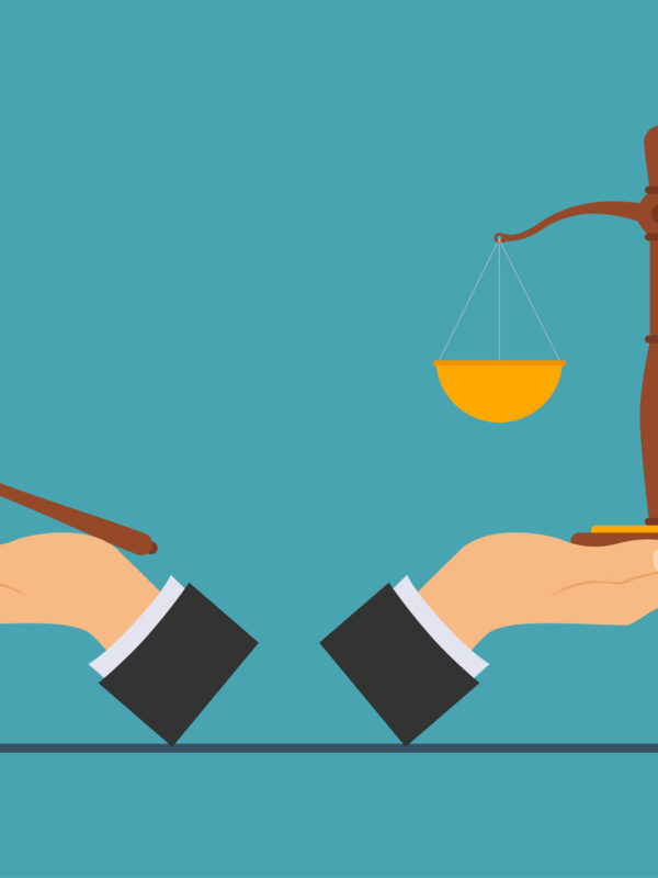 hands holding legal scales and gavel