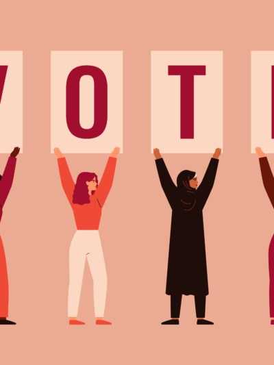 people holding up voting signs