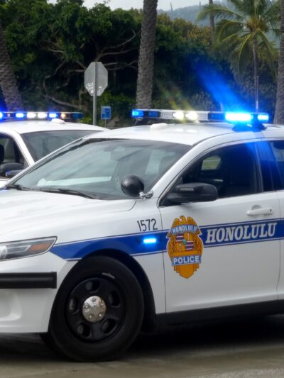 two Honolulu Police cars parked on street