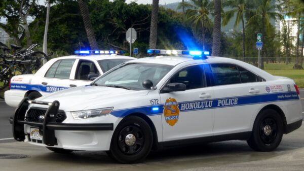 two Honolulu Police cars parked on street