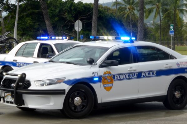 two Honolulu Police cars parked on street