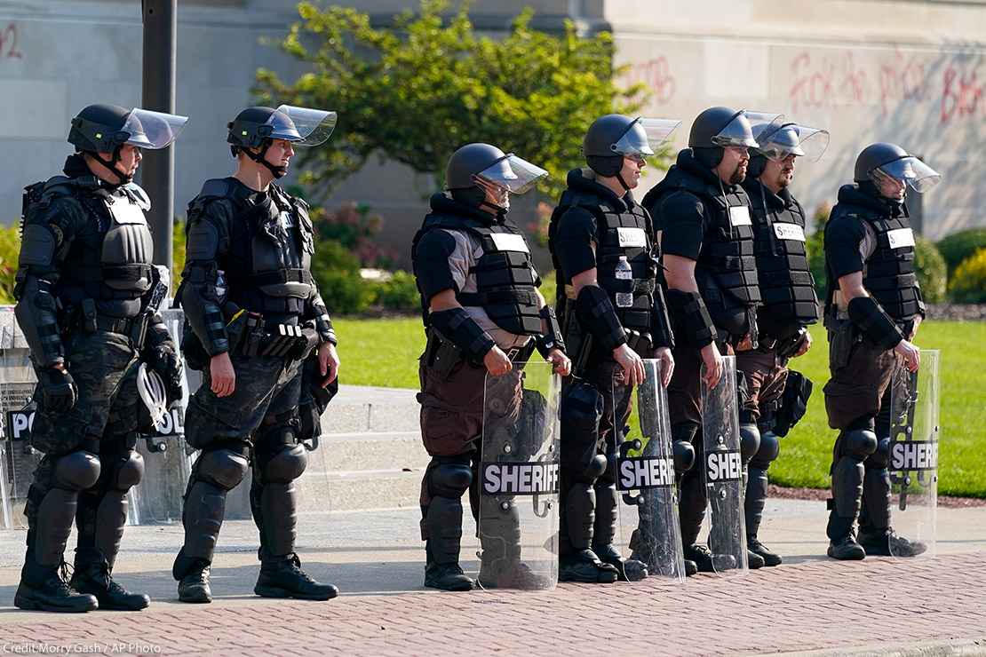 Police in riot gear stand outside the Kenosha County Court House