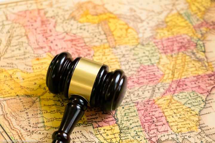 A map of the United States with a gavel on it.